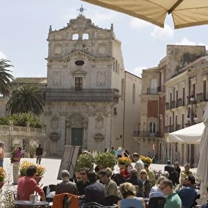 Facade of Santa Lucia alla Badia and cafe in the Piazza Duomo