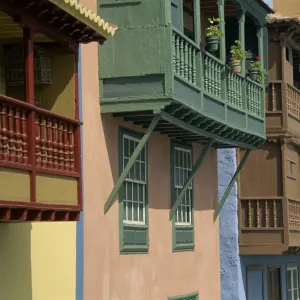 Facades of painted houses with overhanging wooden balconies in Santa Cruz de la Palma