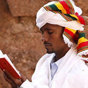 Faithful reading outside a church in Lalibela, Ethiopia, Africa