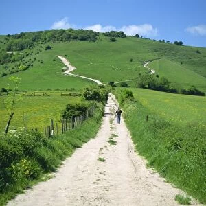 Figure on a pathway leading up a hill in the South Downs, near Lewes, Sussex