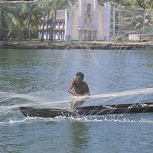 Fisherman casting his throw net in the coastal backwaters