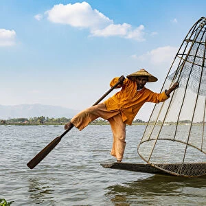 Fisherman at Inle Lake with traditional Intha conical net, fishing net, leg rowing style