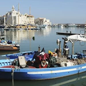 A fishing boat in the harbour by the cathedral of St. Nicholas the Pilgrim (San Nicola