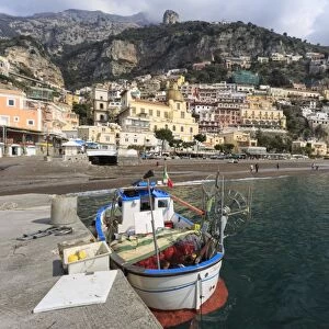 Fishing boat at quayside and Positano town, Costiera Amalfitana (Amalfi Coast), UNESCO