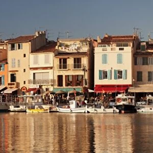 Fishing boats at the harbour, restautants and street cafes on the promenade, Cassis