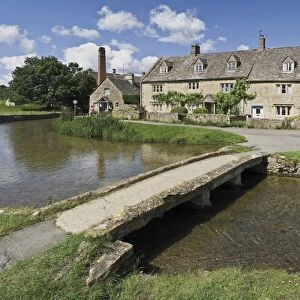 Footbridge over River Eye, Lower Slaughter village, the Cotswolds, Gloucestershire