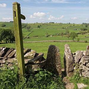 Footpath sign and stone stile with dry stone wall, near Alstonefield, Peak District National Park, Staffordshire, England, United Kingdom, Europe