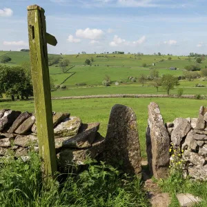 Footpath sign and stone stile with dry stone wall, near Alstonefield, Peak District National Park, Staffordshire, England, United Kingdom, Europe