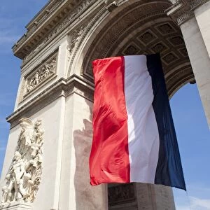 French flag under Arc de Triomphe built by Napoleon, Paris, France, Europe