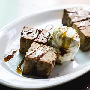 Fried Gofio, flour of roasted and ground cereal, in shape of brownies with ice cream
