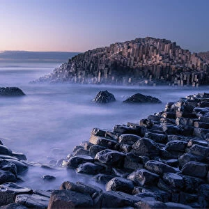 The Giants Causeway rises out of the Atlantic late at night as the last light of