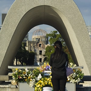 Girl praying at cenotaph
