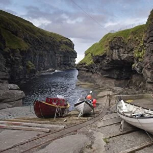 Gjogv harbour, set in a 200m-long natural cleft in the rock, Eysturoy, Faroe Islands