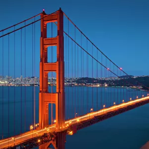 The Golden Gate Bridge, from the Marin Headlands at night with the city of San Francisco in the background and traffic light trails across the bridge, Marin County, San Francisco, California, United States of America