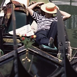 Gondolier relaxing in gondola