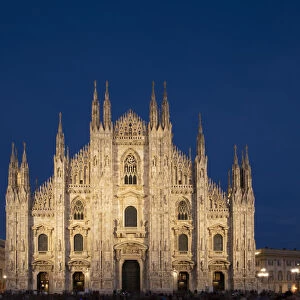 Gothic spires on the facade of the Milan Cathedral in the Piazza del Duomo at dusk, Milan