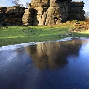 Gritstone formations at Brimham Rocks reflected in frozen flood water, Summerbridge, North Yorkshire, Yorkshire, England, United Kingdom, Europe