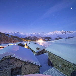 Groppera stone huts covered with snow during a starry night, Madesimo, Valchiavenna