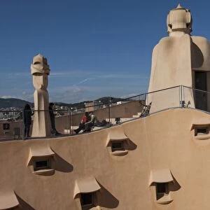 Group of four grotesque chimneys on the roof of La Pedrera (Casa Mila), and roof window details on an apartment block designed by Antonio Gaudi, UNESCO World Heritage Site, Passeig de Gracia, Barcelona, Catalunya, Spain, Europe