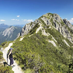 Hiker on Gratweg Trail from Heimgarten to Herzogstand Mountain, Upper Bavaria, Bavaria