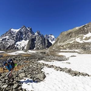 Hiker on a mountain trail, Barre des Ecrins, Ecrins National Park, French Dauphine Alps