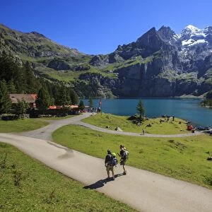 Hikers around Lake Oeschinensee, Bernese Oberland, Kandersteg, Canton of Bern, Switzerland