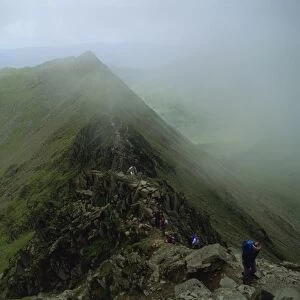 Hikers on Striding Edge, from Helvellyn, Lake District National Park, Cumbria
