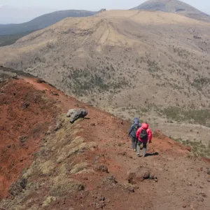 Hikers, volcanic scenery and hiking trail