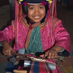 Hill tribe girl weaving on a narrow loom in Chiang Mai