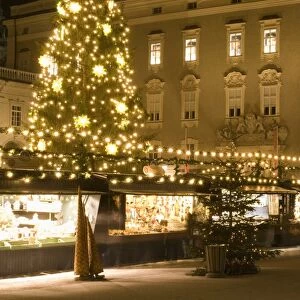 Historical Salzburg Christkindlmarkt (Christmas market) with stalls and Rezidens building at night