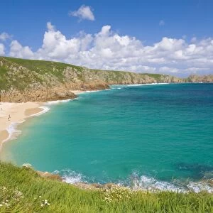 Holidaymakers and tourists sunbathing on Porthcurno beach, Cornwall, England