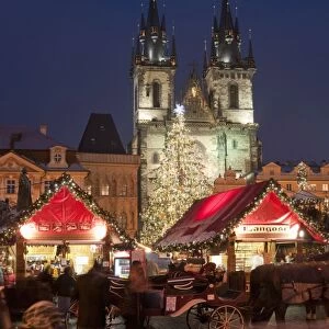 Horse drawn carriage at Christmas Market and Gothic Tyn Church at twilight