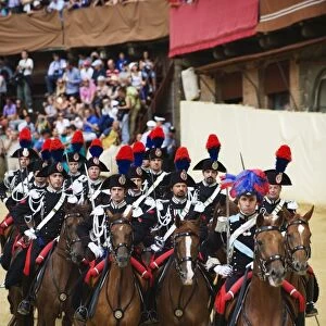 Horses and guards parading at El Palio horse race festival, Piazza del Campo