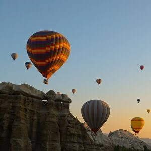 Hot air balloons cruising over Cappadocia, Anatolia, Turkey, Asia Minor, Eurasia