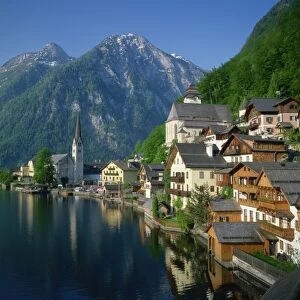 Houses, chalets and the church of the village of Hallstatt beside the lake