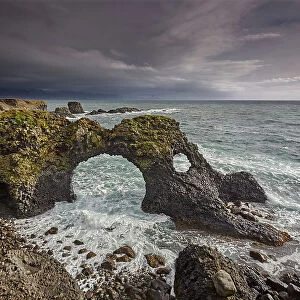 A huge lava arch, pounded by Atlantic surf, at Arnastapi, in Snaefellsjokull National Park, on the Snaefellsnes peninsula, west coast of Iceland, Polar Regions