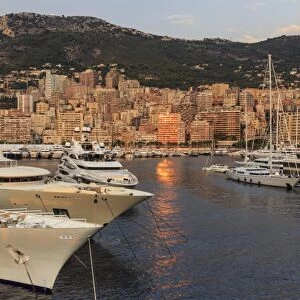 Huge super yachts in the glamorous Port of Monaco (Port Hercules) at sunrise, from the sea