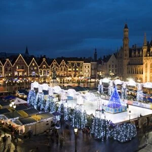 Ice Rink and Christmas Market in the Market Square, Bruges, West Vlaanderen (Flanders), Belgium, Europe