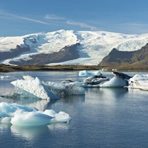 Icebergs floating on Jokulsarlon Glacial Lagoon with Hvannadalshnukur Peak in the background