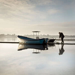 A very icy cold morning on Hornsea Mere as the boats and jetty are prepared for the