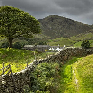 Idyllic farm and countryside view with dry stone wall in the Langdale Valley, Lake