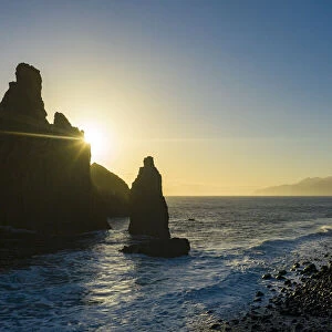 Ilheus da Rib and Ribeira da Janela rock formations lit by sun rays at dawn