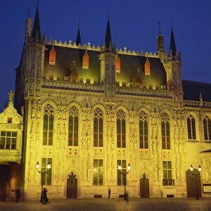 The illuminated facade of the Town Hall in Burg Square in Bruges, at night