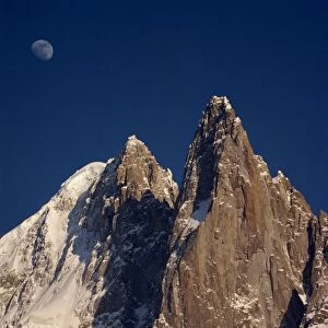 Jagged peak of Aiguille du Dru and the moon