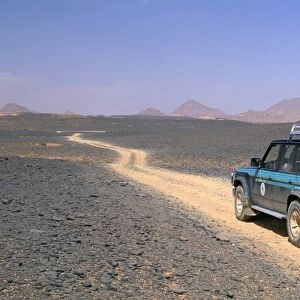 Jeep driving on stone desert, Akakus, Sahara desert, Fezzan, Libya, North Africa, Africa