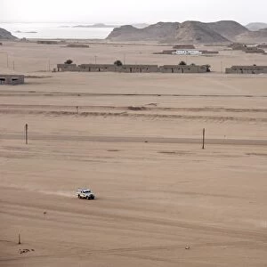 Jeeps cover the wide expanse of desert between Lake
