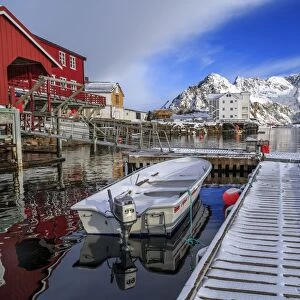 Jetty covered with snow after a night snowfall and boats docked in the harbor of Henningsvaer, Lofoten Islands, Arctic, Norway, Scandinavia, Europe