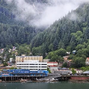 Juneau, State Capital, view from the sea, mist clears over downtown buildings, mountains