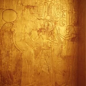 Detail of the king wearing Osiris crown with gods Reherakte and Maat on shrine of Tutankhamun