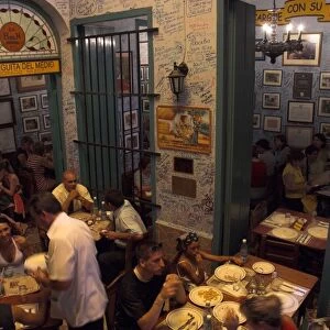 La Bodeguita del Medio restaurant, with signed walls and people eating at tables